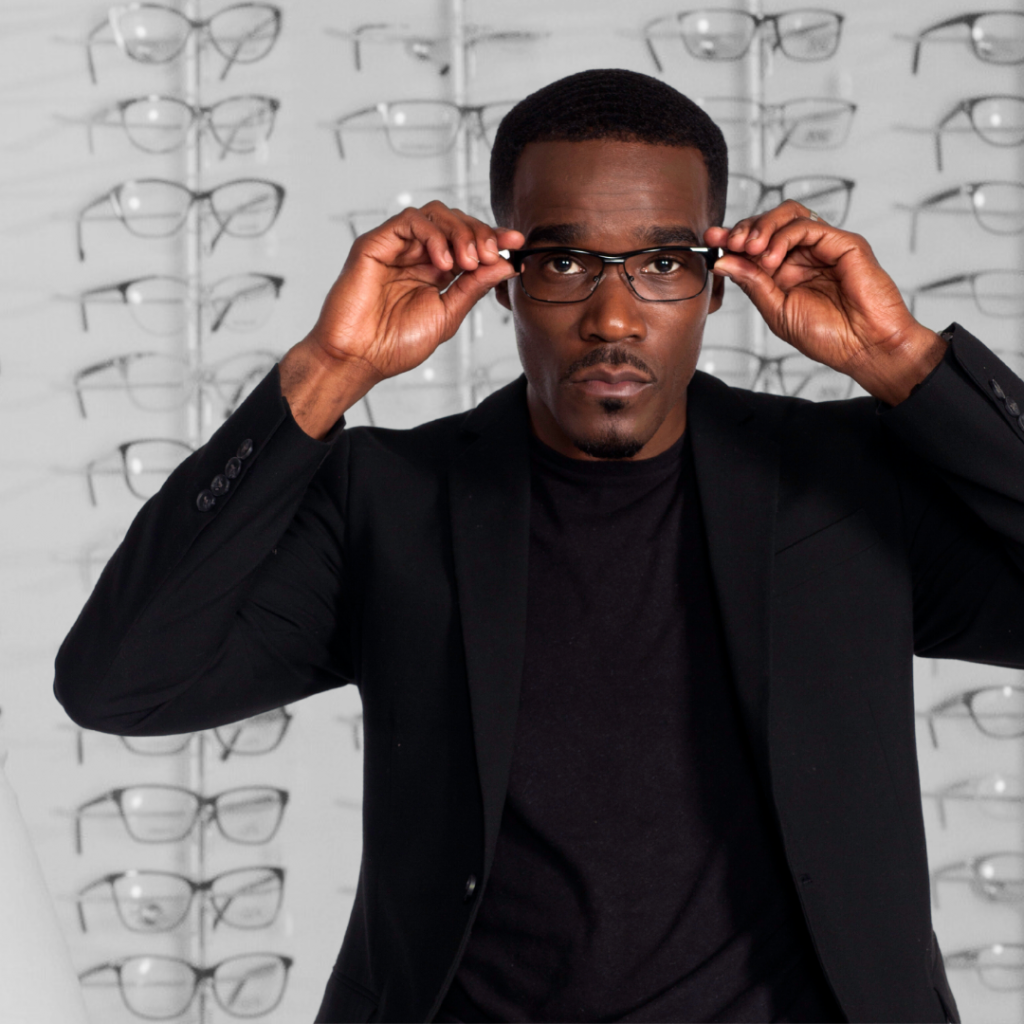 Black man putting on eyeglasses